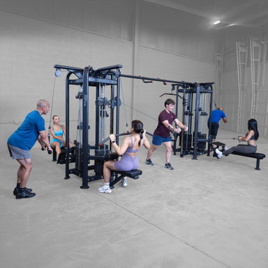 Body-Solid Pro ClubLine SJG Jungle Gym SJG800 Multiple users working out together on dual adjustable pulley system performing cable flys, rows, and lat pulldowns.

