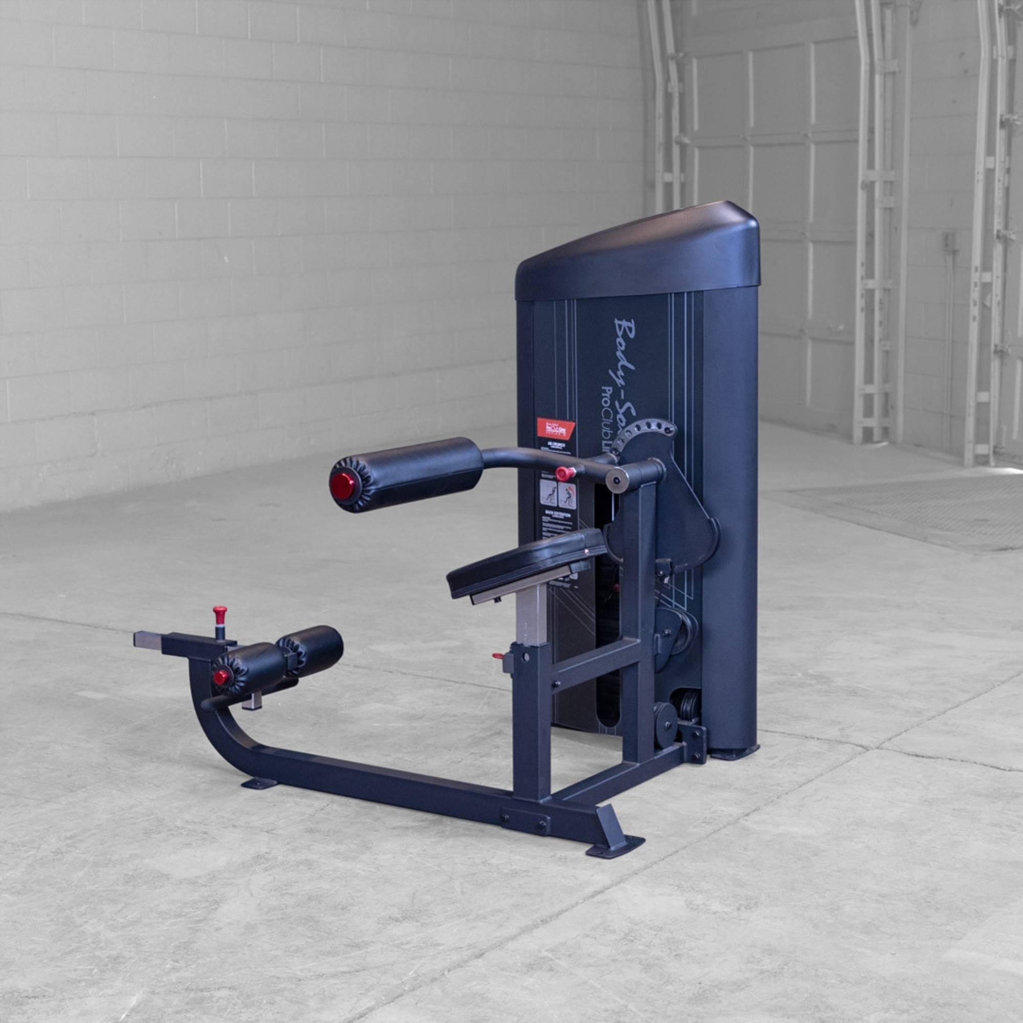 Body-Solid Pro ClubLine Series 2 Ab and Back S2ABBX Body-Solid ProClubLine seated leg curl machine with padded rollers and adjustable back support in a gym.
