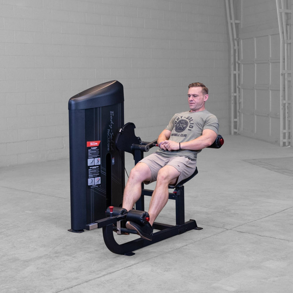 Body-Solid Pro ClubLine Series 2 Ab and Back S2ABBX Man leaning back for controlled back extension on Body-Solid ProClubLine ab crunch and extension combo machine.
