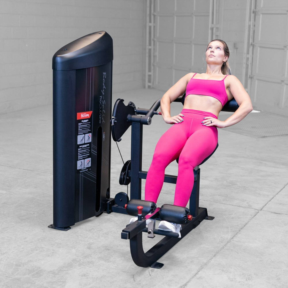 Body-Solid Pro ClubLine Series 2 Ab and Back S2ABBX Woman leaning back while performing supported leg extension exercise on Body-Solid ProClubLine machine.

