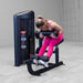 Body-Solid Pro ClubLine Series 2 Ab and Back S2ABBX Woman performing seated hamstring curl on a Body-Solid ProClubLine leg curl machine while wearing bright pink athletic attire.
