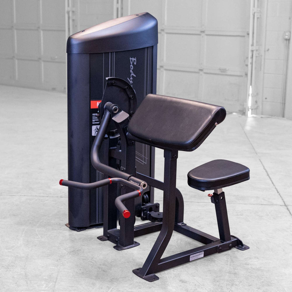 Body-Solid Pro ClubLine Series 2 Arm Curl S2ACX Body-Solid ProClubLine arm curl machine with padded preacher curl support and dual-grip curl handles in a gym.
