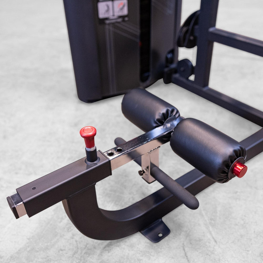 Body-Solid Pro ClubLine Series 2 Arm Curl S2ACX Close-up of adjustable padded leg rollers with a red pin selector on Body-Solid ProClubLine leg curl machine.
