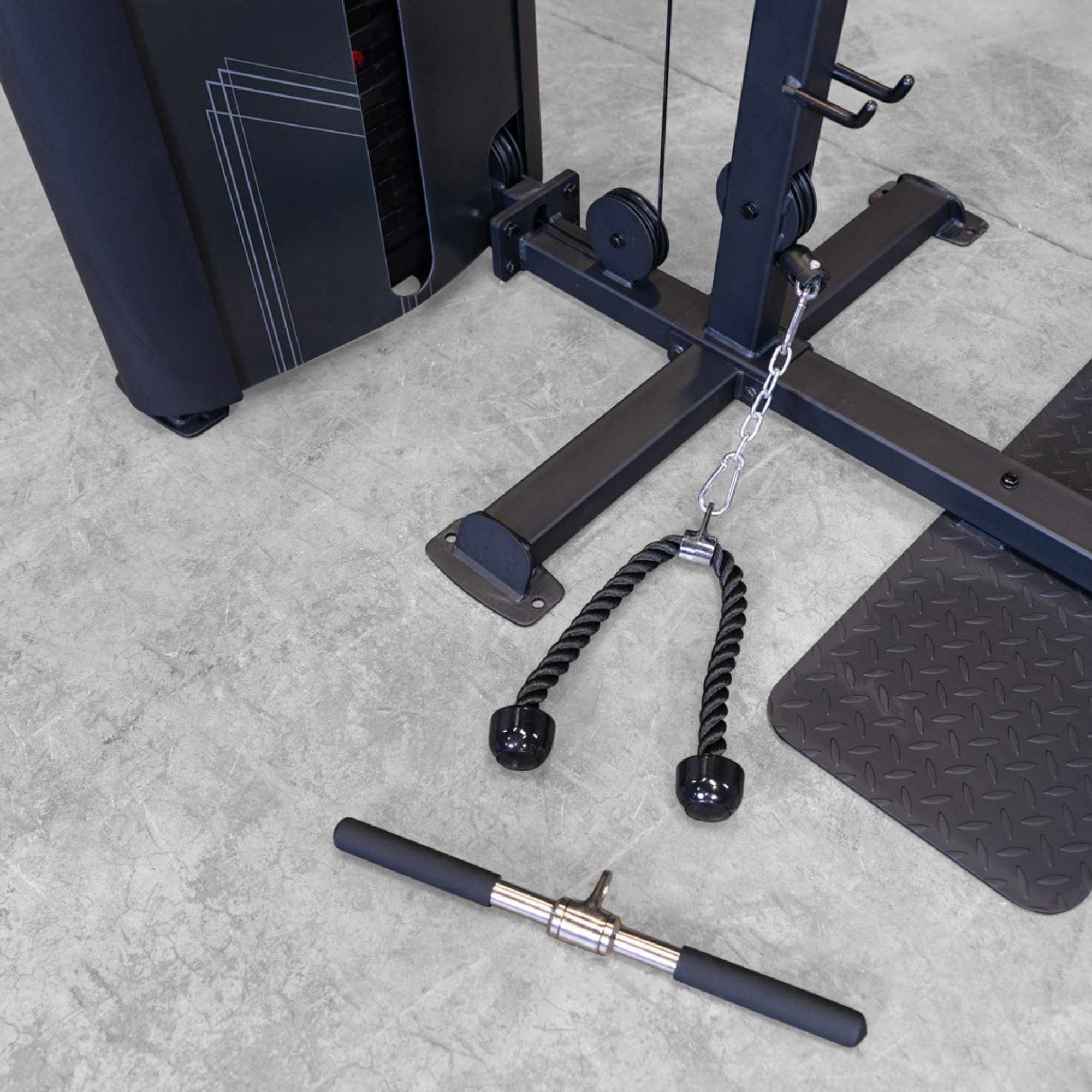 Body-Solid Pro ClubLine Series 2 Biceps Triceps S2BTPX Close-up view of cable attachment accessories including tricep rope and straight bar positioned near the base of the Body-Solid ProClub Line machine