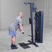 Body-Solid Pro ClubLine Series 2 Biceps Triceps S2BTPX Man bent slightly forward performing cable tricep pushdowns on a Body-Solid cable machine in a concrete-floor gym.