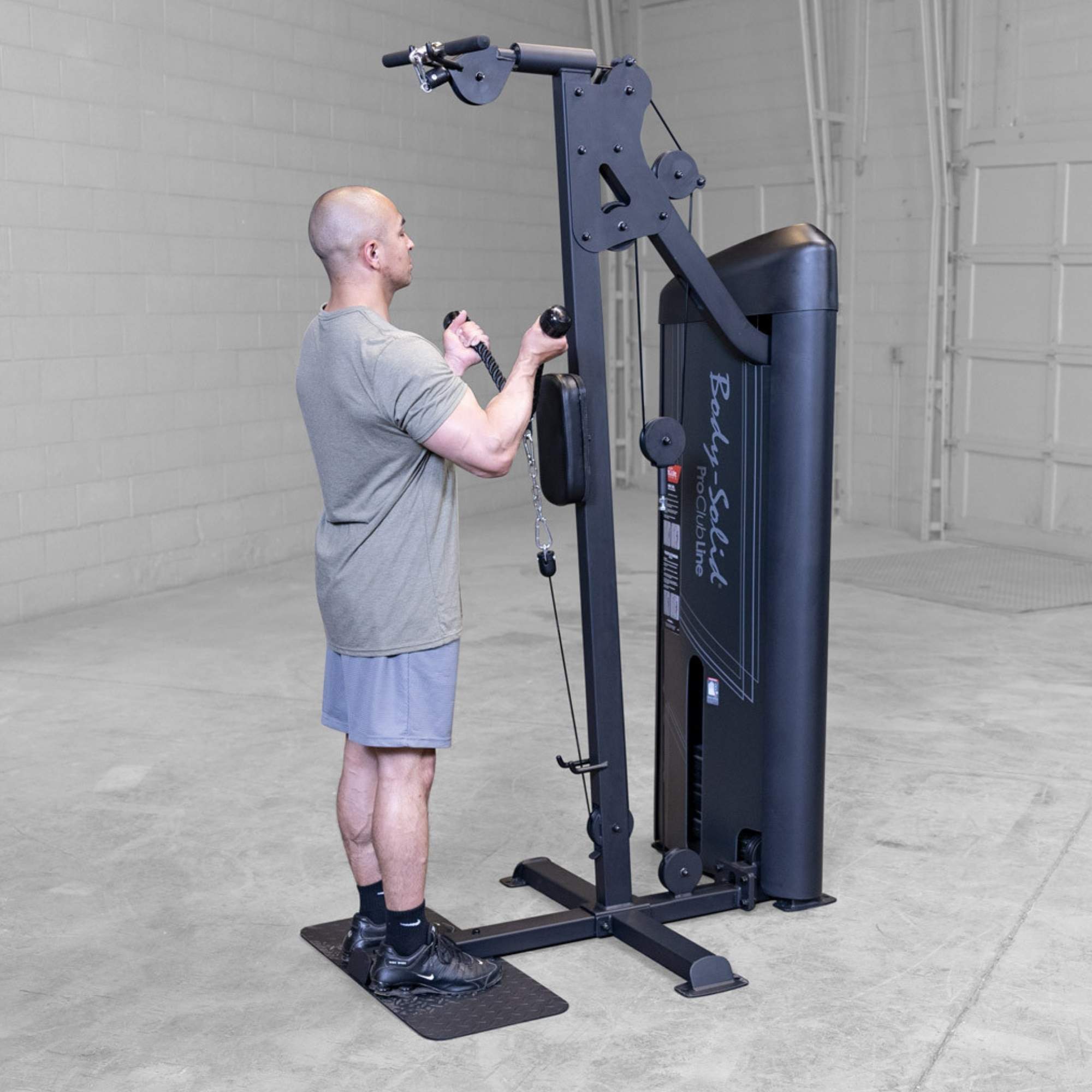 Body-Solid Pro ClubLine Series 2 Biceps Triceps S2BTPX Man doing single-rope cable curls, standing upright beside a black Body-Solid gym machine.