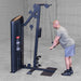 Body-Solid Pro ClubLine Series 2 Biceps Triceps S2BTPX Man leaning forward performing tricep cable pushdowns on a high pulley machine in an industrial-style gym