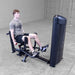 Body-Solid Pro ClubLine Series 2 Inner Outer Thigh S2IOTX Back view of man performing seated hip abduction exercise on a Body-Solid machine inside a spacious gym