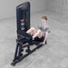 Body-Solid Pro ClubLine Series 2 Leg Calf Press S2LPCX Gym equipment demonstration showing man seated on leg press machine preparing to extend legs for lower-body workout