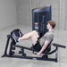 Body-Solid Pro ClubLine Series 2 Leg Calf Press S2LPCX Man performing seated leg press exercise on a Body-Solid ProClubLine machine with knees bent in starting position
