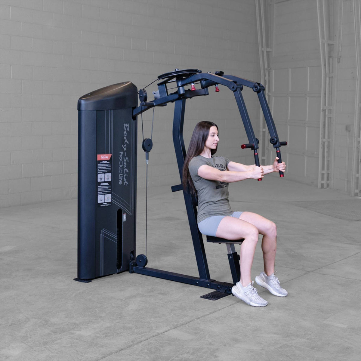 Body-Solid Pro ClubLine Series 2 Pec Delt S2PECX Woman using Body-Solid ProClub Line pec deck machine with arms extended forward during chest fly exercise