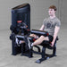 Body-Solid Pro Clubine Series 2 Leg Curl and Extension S2LECX Young man Performing controlled return phase of the leg extension exercise in a gym 
