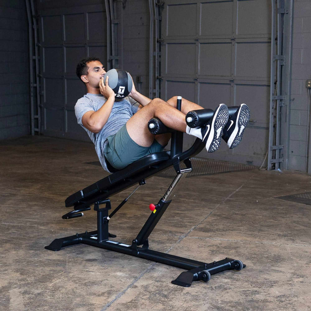Body-Solid Proclub Commercial Ab Bench SAB500B Man performing weighted sit-ups on an adjustable bench
