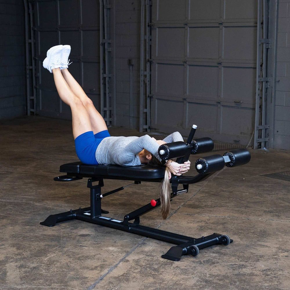 Body-Solid Proclub Commercial Ab Bench SAB500B Woman doing leg raise on a flat exercise bench