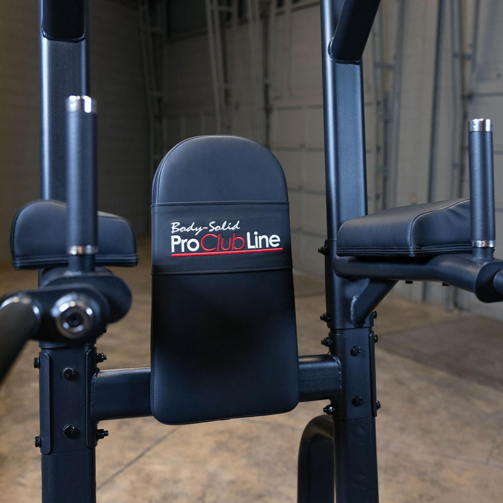 Body-Solid Proclub Vertical Knee Raise SVKR1000BX Back pad and arm supports on a Body-Solid Pro Club Line power tower, shown from the front at standing height.
