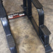 Body-Solid Proclub Vertical Knee Raise SVKR1000BX Heavy-duty steel base of a Body-Solid Pro Club Line power tower with textured foot platforms on a concrete gym floor.