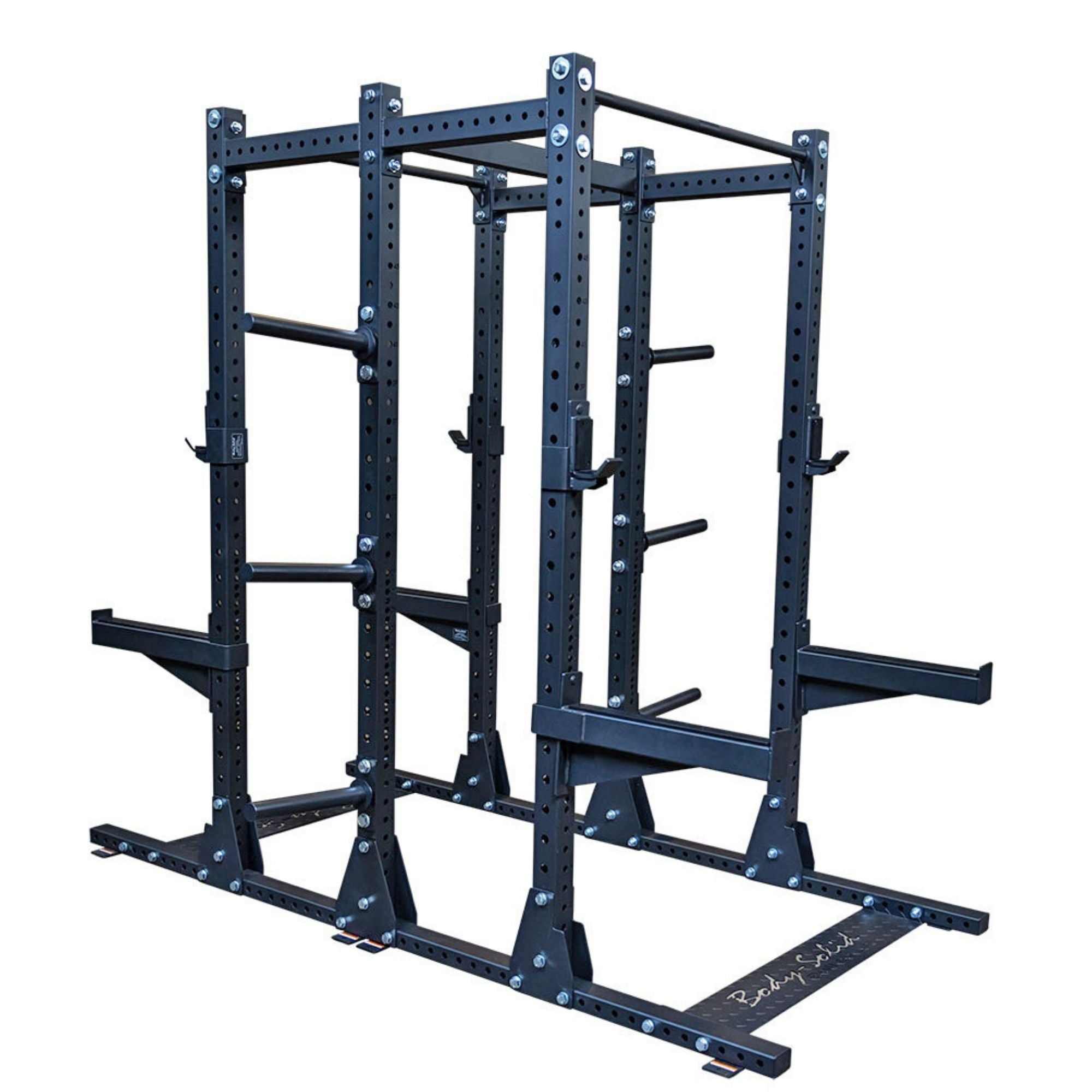 Body-Solid SPR500DBL Commercial Double Half Rack in black finish, dual-station frame with J-cups, safety arms, and plate storage posts.
