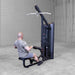 Body-Solid Series 2 Lat Mid Row S2LATX  Back view of man performing a low row cable movement on the Body-Solid ProClub Line strength machine