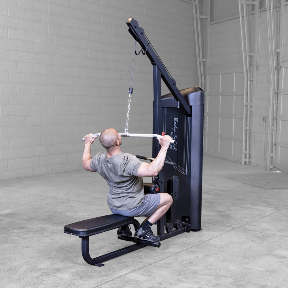 Body-Solid Series 2 Lat Mid Row S2LATX  Rear angle of man performing a lat pulldown on the Body-Solid ProClub Line machine, pulling the bar down toward his shoulders