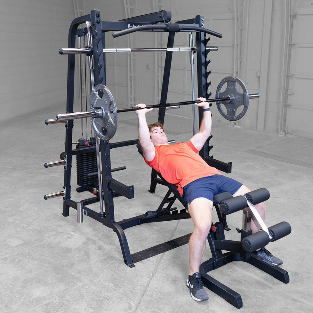 Body-Solid Series 7 Smith Machine Gym Package GS348QB4 Man doing incline bench press with barbell inside Body-Solid Smith machine