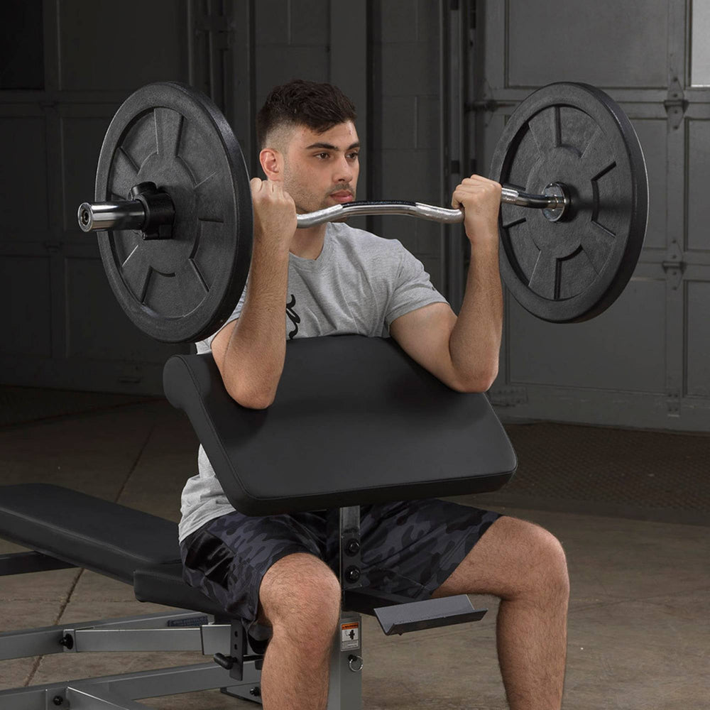 Body-Solid Series 7 Smith Machine Gym Package GS348QB4 Man performing seated barbell curls on preacher curl bench