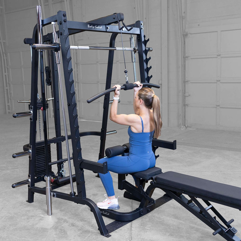 Body-Solid Series 7 Smith Machine Gym Package GS348QB4 Woman performing lat pulldown on Body-Solid Smith machine with attachments