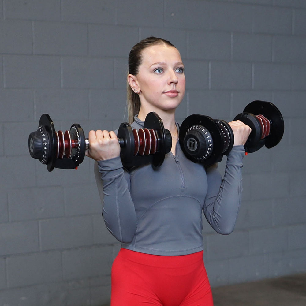 Body-Solid Tools Adjustable Dumbbell Set, 11 lb. to 66 lb. with Stand SDBX132ST Woman performing standing bicep curls with adjustable dumbbells