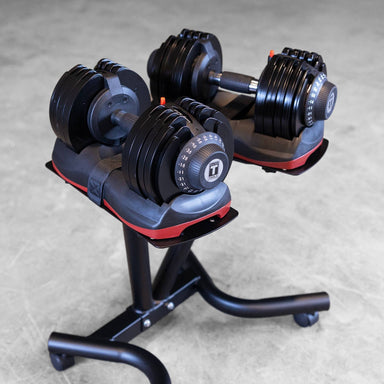 Body-Solid Tools Adjustable Dumbbell Set, 11 lb. to 66 lb. with Stand SDBX132ST djustable dumbbells placed on a rolling dumbbell stand in a gym