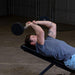 Body-Solid Tools Fixed Weight EZ Curl Barbells, from 20 to 110 lb. Man doing incline tricep extensions using 40 lb curl bar on weight bench