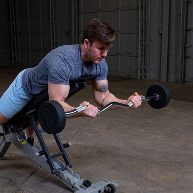 Body-Solid Tools Fixed Weight EZ Curl Barbells, from 20 to 110 lb. Man performing incline bench barbell curls with 40 lb EZ curl bar for bicep isolation