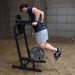 Body-Solid Vertical Knee Raise and Dip GVKR60B Man performing weighted dips using a Body-Solid VKR station and a dip belt with weight plates