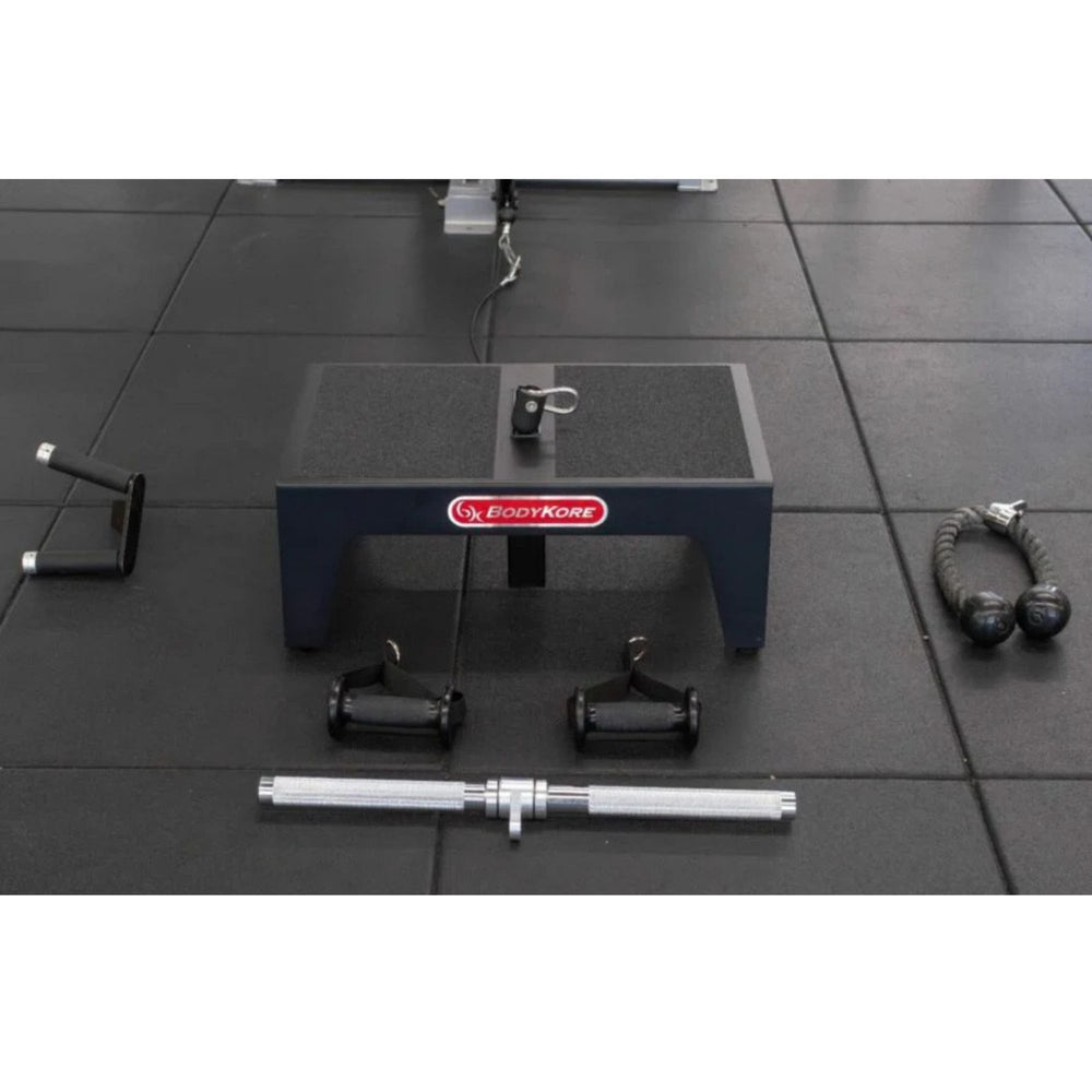 BodyKore Squat Box Belt Squat Platform MX1182 with attached pulley and cable, surrounded by various cable machine 
