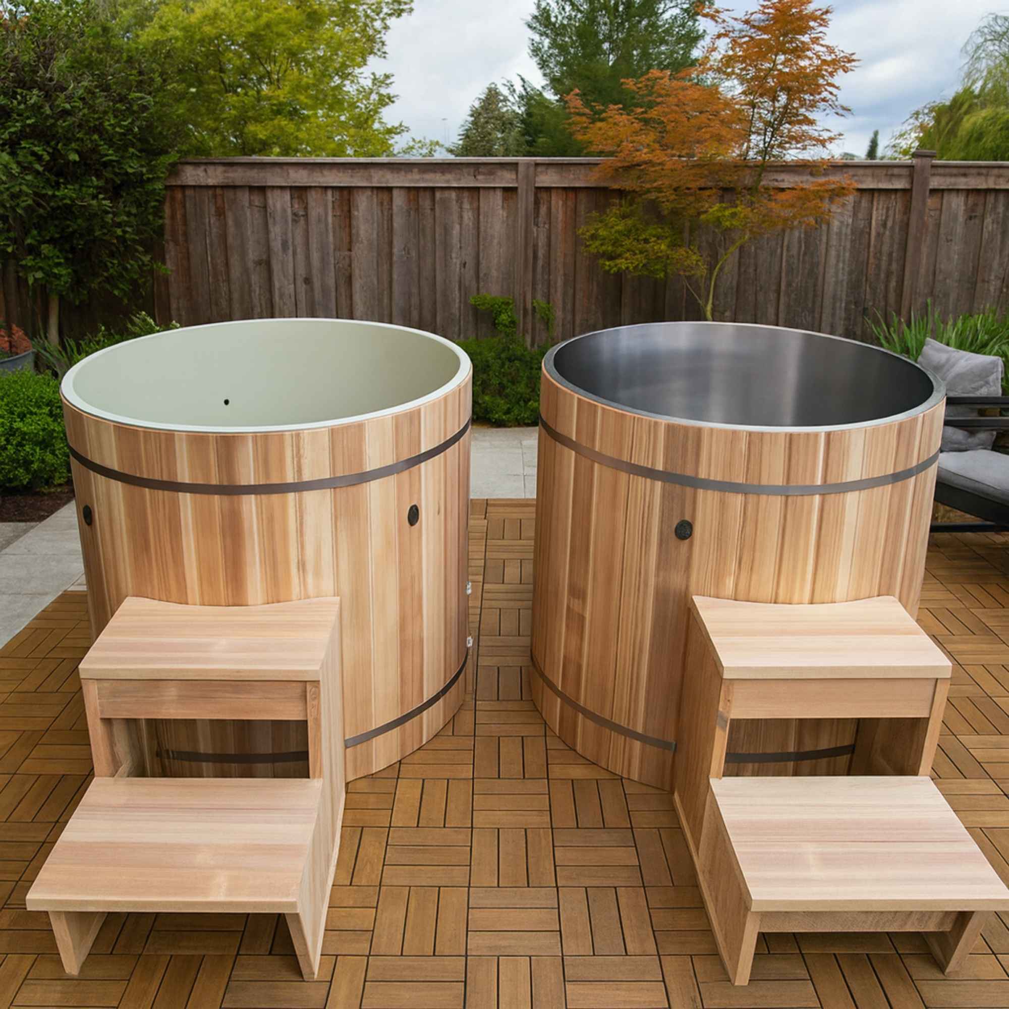 Two wooden Dynamic cold plunges with steps on a wooden deck outdoors.