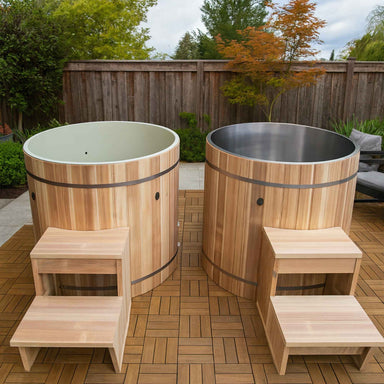 Two wooden Dynamic cold plunges with steps on a wooden deck outdoors.