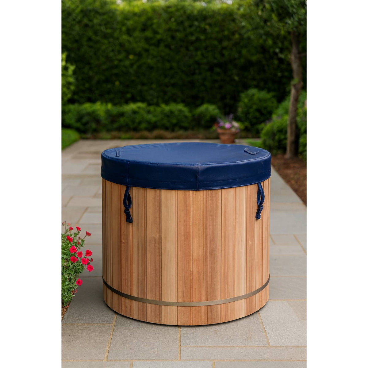 Wooden Dynamic cold plunge barrel with blue cover on a patio