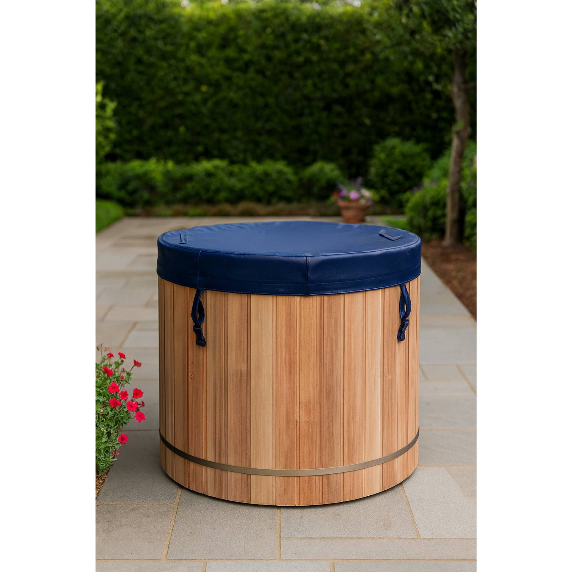 Wooden Dynamic cold plunge barrel with blue cover on a patio