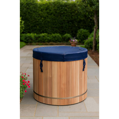 Wooden Dynamic cold plunge barrel with blue cover on a patio