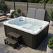 Luxury Spas Solace hot tub with steps in a patio setting
