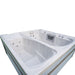 A white double Luxury Spas USA Marquis Hot & Cold Contrast Therapy Spa hot tub with multiple jet nozzles and a vented control panel, shown on a plain white background.