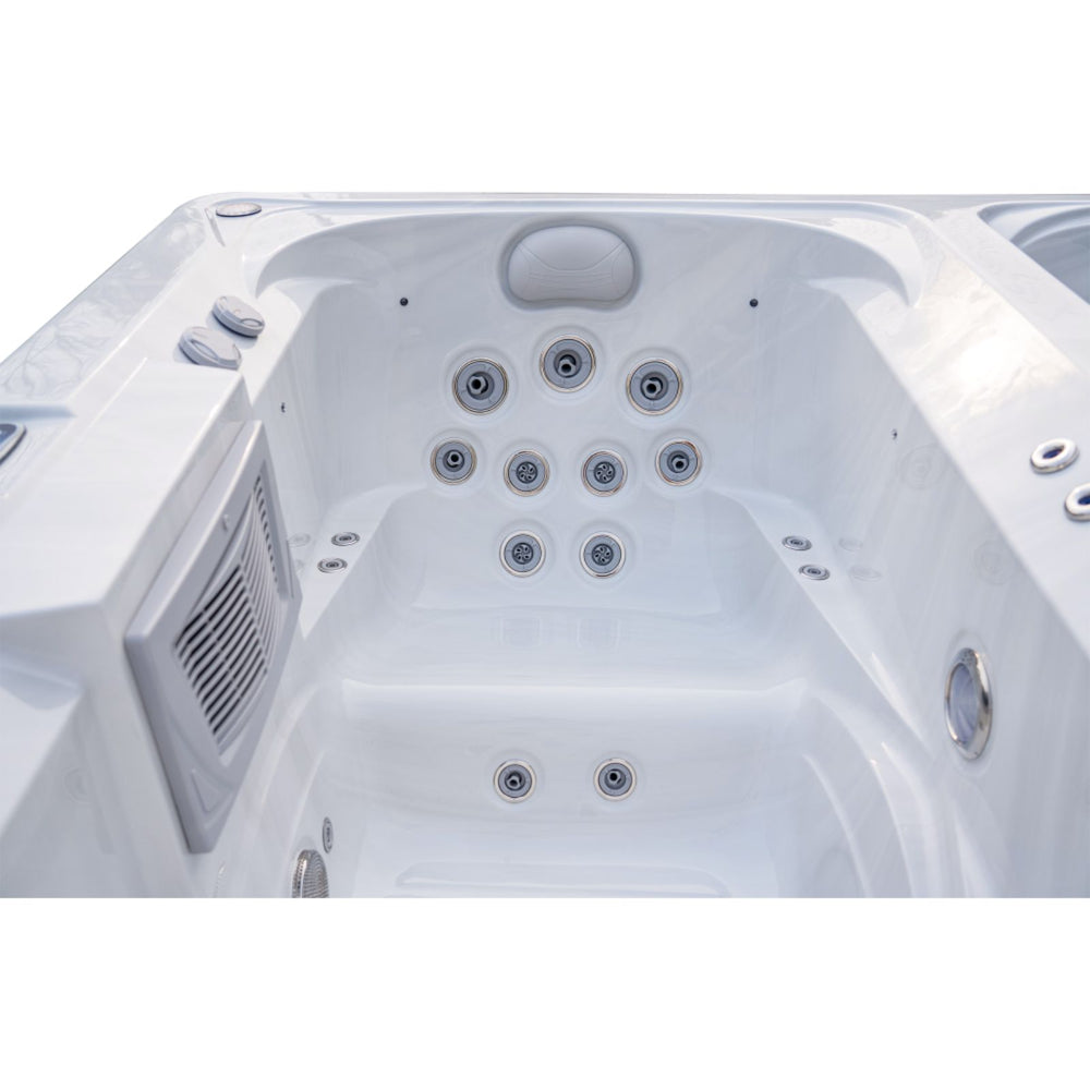 White outdoor Luxury Spas USA Marquis Hot & Cold Contrast Therapy Spa tub with multiple jet nozzles, side controls, and a vented panel, shown from a top-down angle on a white background.