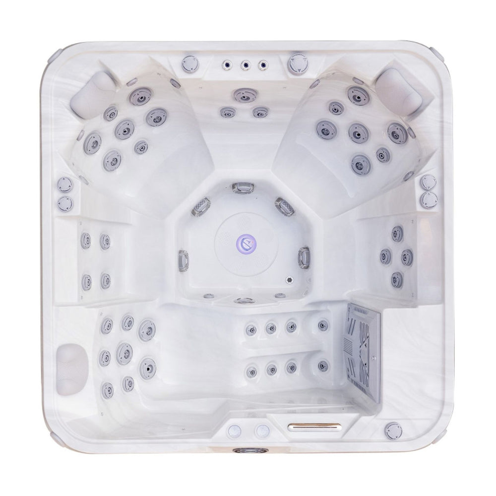 Top-down view of a white multi-seat Luxury Spas Liberty 5-Person hot tub with multiple jet nozzles and built-in lighting, isolated on a white background.