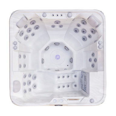 Top-down view of a white multi-seat Luxury Spas Liberty 5-Person hot tub with multiple jet nozzles and built-in lighting, isolated on a white background.