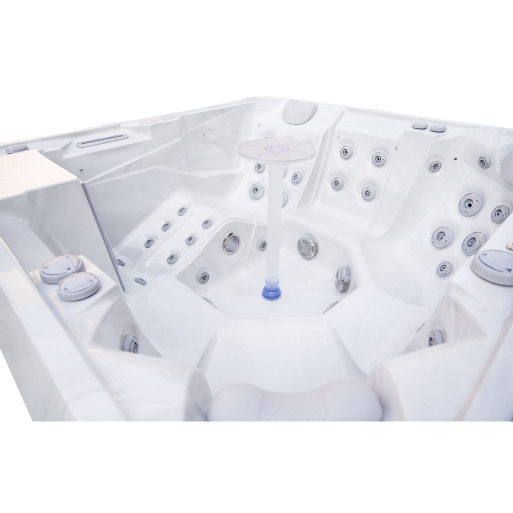 A white Luxury Spas Liberty 5-Person hot tub with multiple jet nozzles and a central column, photographed from an elevated angle against a white background.