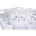 A white Luxury Spas Liberty 5-Person hot tub with multiple jet nozzles and a central column, photographed from an elevated angle against a white background.