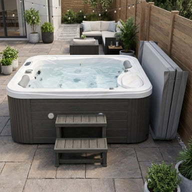 Luxury Spas-Casey-3-Person-Hot tub on a patio with outdoor furniture and plants