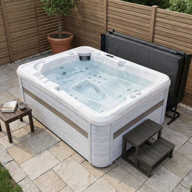 Luxury Spas Largo hot tub filled with water on a small patio
