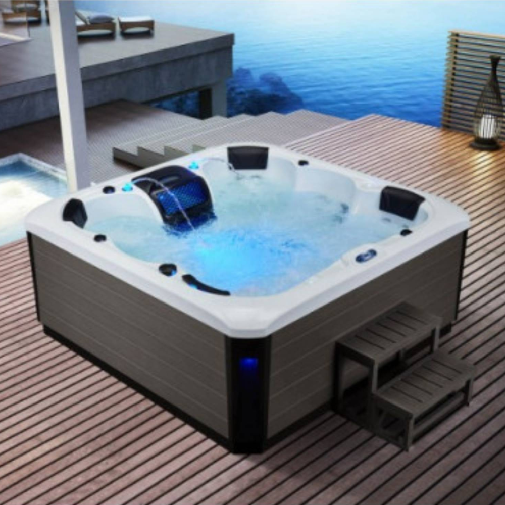 Hot tub on a wooden deck with water features and outdoor setting