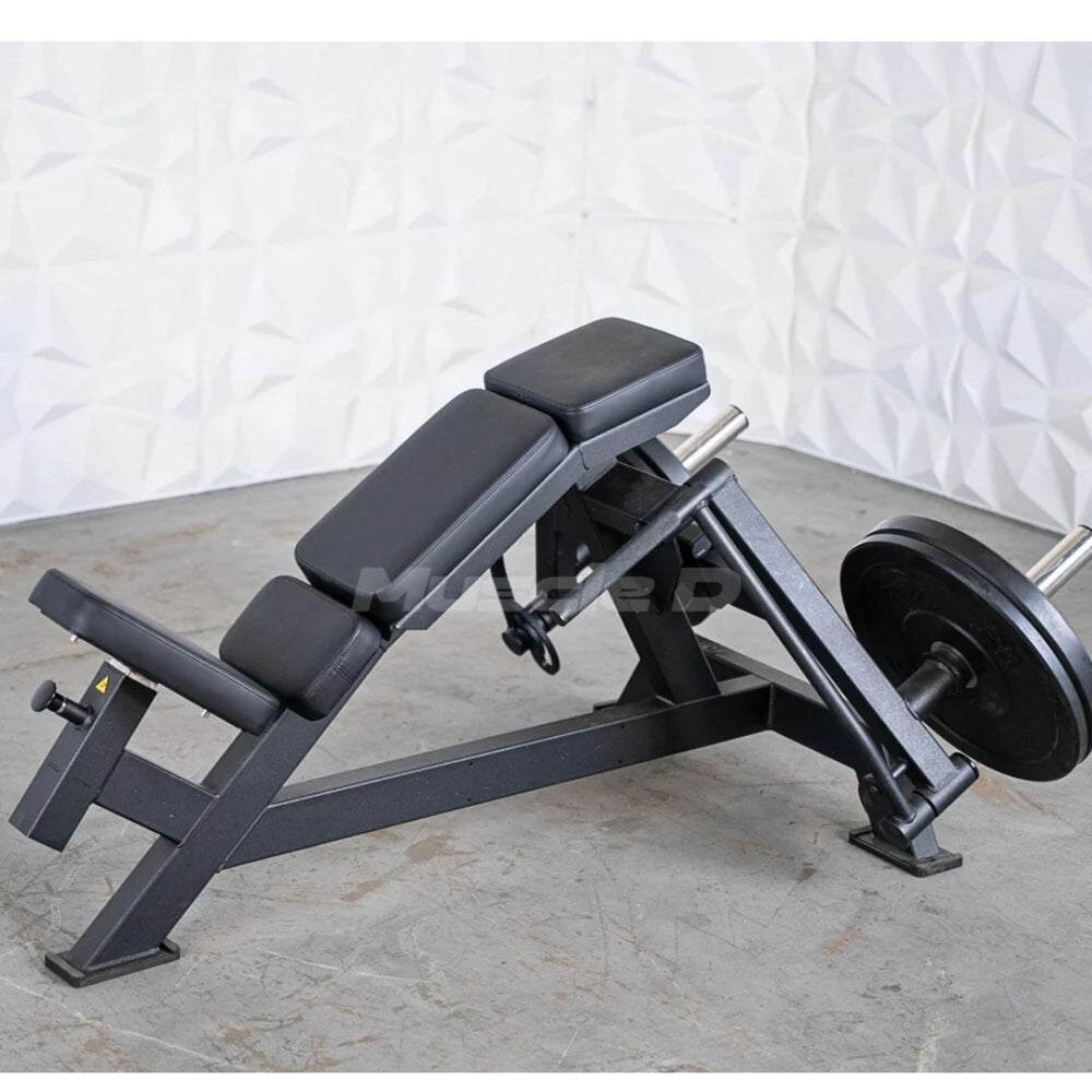Muscle D weight leverage pec fly bench with a weigh post loaded with black weight plates, set on a gray concrete floor against a white textured wall.
