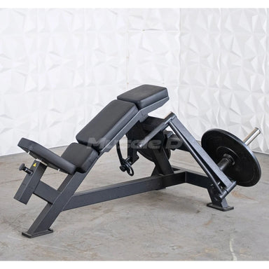 Muscle D weight leverage pec fly bench with padded black seat and backrest, mounted on a dark metal frame with a barbell and weight plate, photographed against a textured white wall and concrete floor.