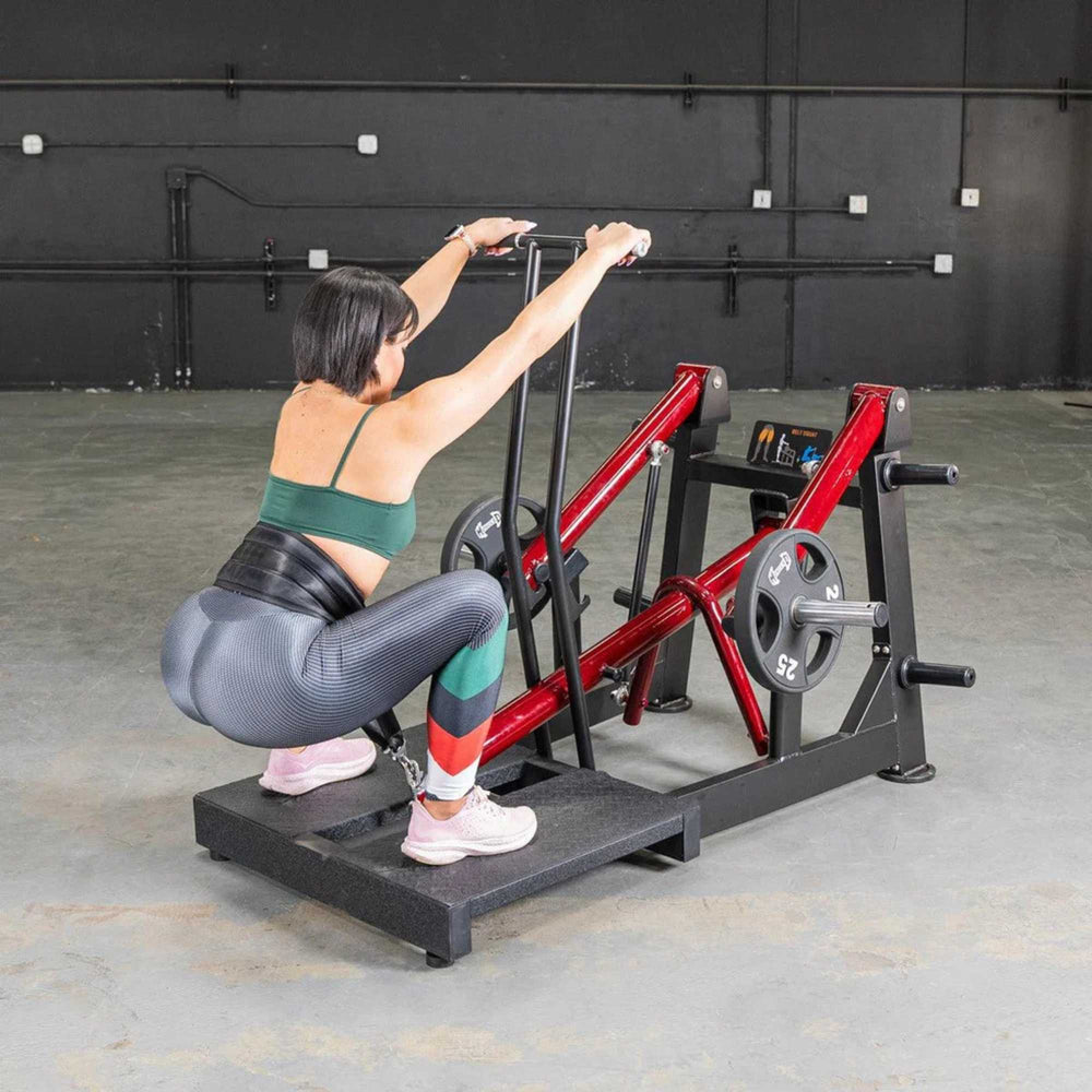 Muscle D Power Leverage V2 Belt Squat PL-PV2-BS performed by a woman using 25 lb Olympic plates, targeting lower body muscles.